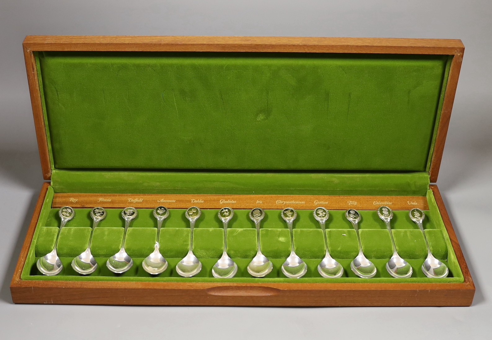 A cased set of twelve commemorative Royal Horticultural Society flower spoons, with silver gilt finials, gross 10oz